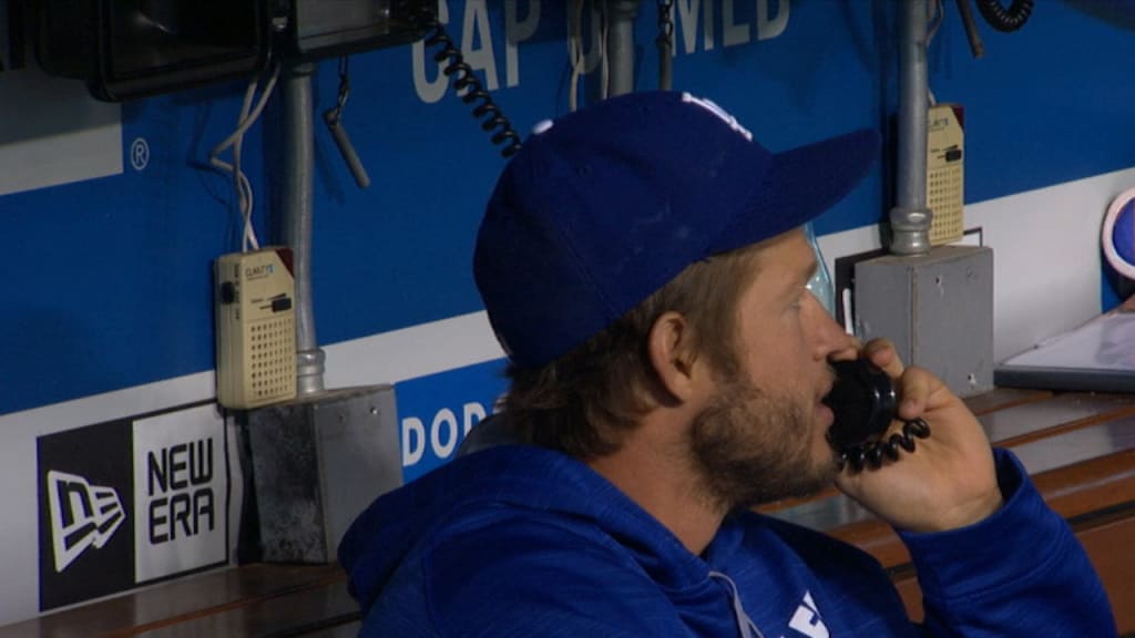 Clayton Kershaw has some fun on the dugout phone during Thursday's matchup with Miami.