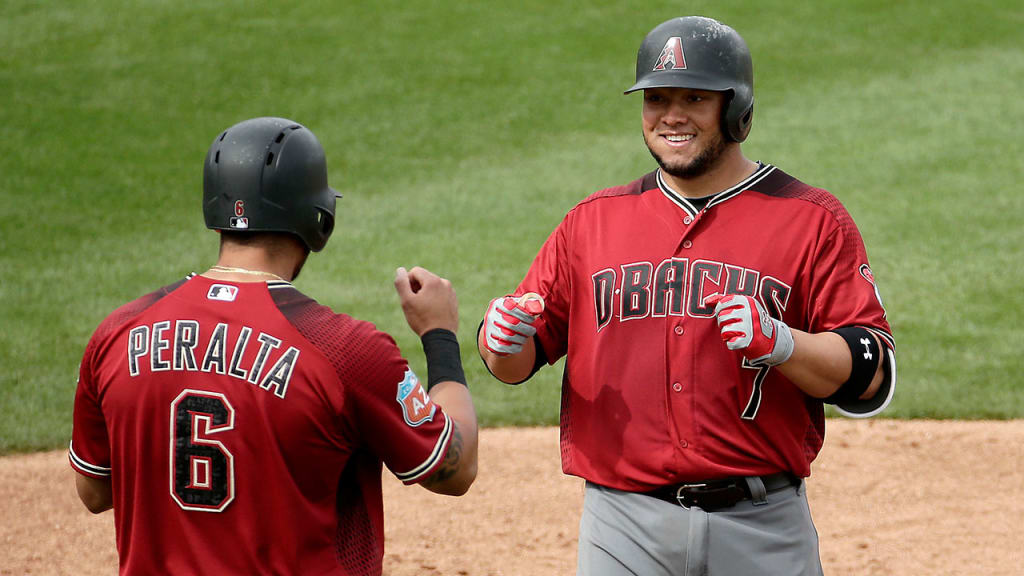Welington Castillo celebrates with David Peralta after Castillo hit a two-run home run during the third inning on Monday.