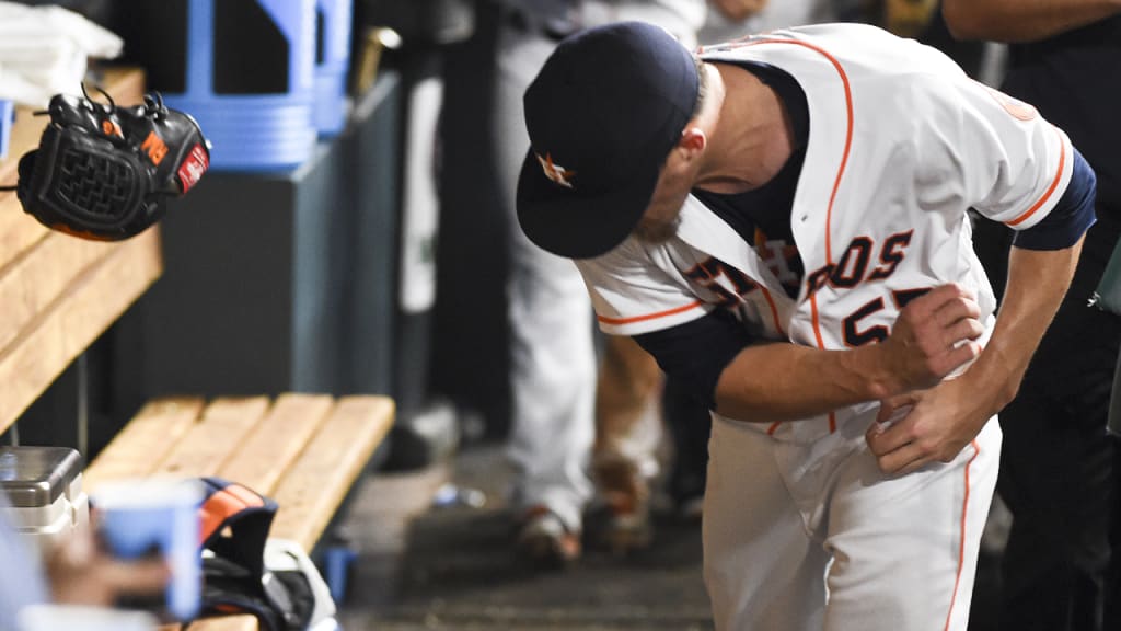 Ken Giles throws his glove in the dugout after a tough eighth inning. (Eric Christian Smith/AP)