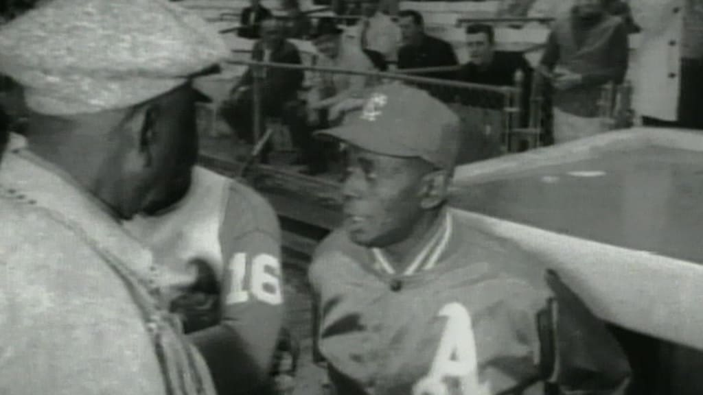 A photo of Atlanta Braves coach Satchel Paige signing autographs in 1969.