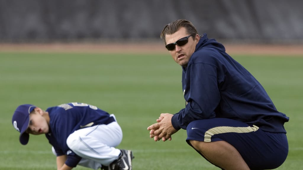 Former San Diego Padres pitcher Trevor Hoffman stands between his wife, Tracy, and one of his sons as he looks at a standing ovation by fans during his induction into the Padres