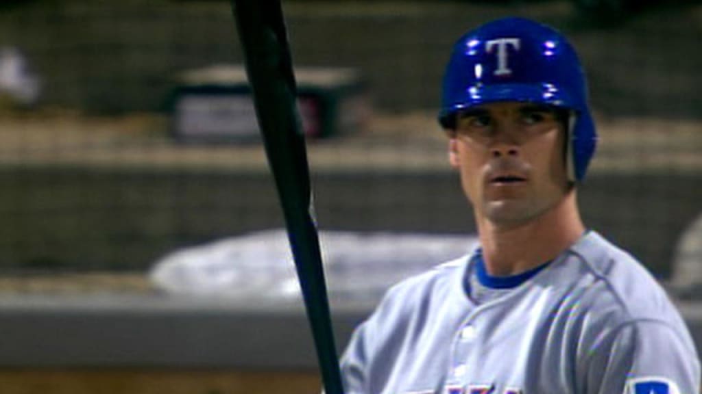 Texas Rangers' Michael Young tips his batting cap to the cheers of