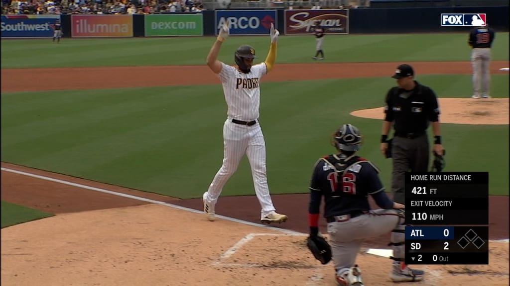 San Diego Padres' Manny Machado blows a gum bubble while watching