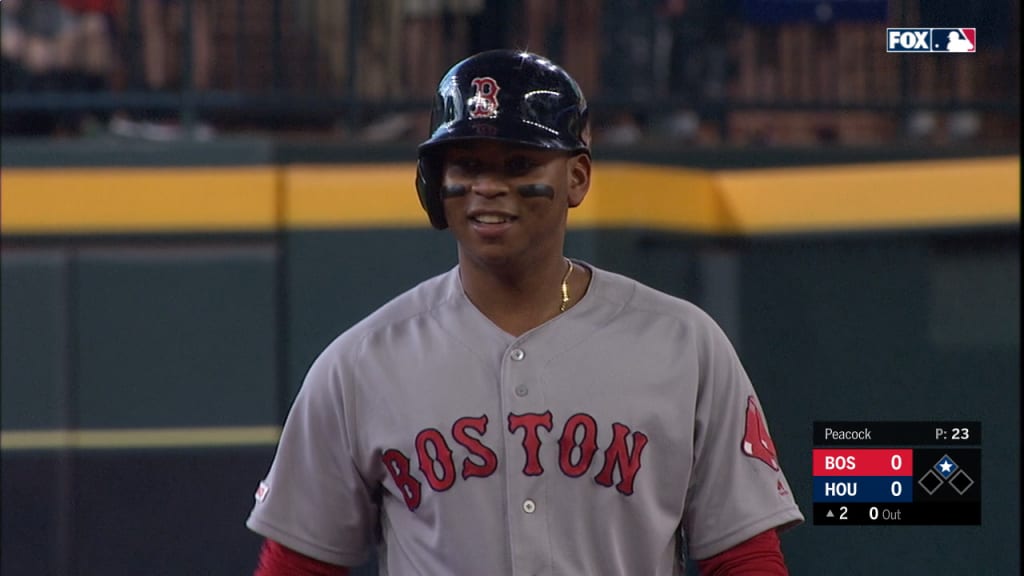 Rafael Devers of the Boston Red Sox plays with his hair as he