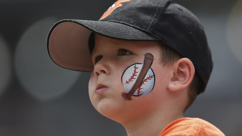 A young baseball fan looks on before the Baltimore Orioles and Detroit Tigers baseball game, Sunday, Aug. 6, 2017, in Baltimore. (AP Photo/Gail Burton)