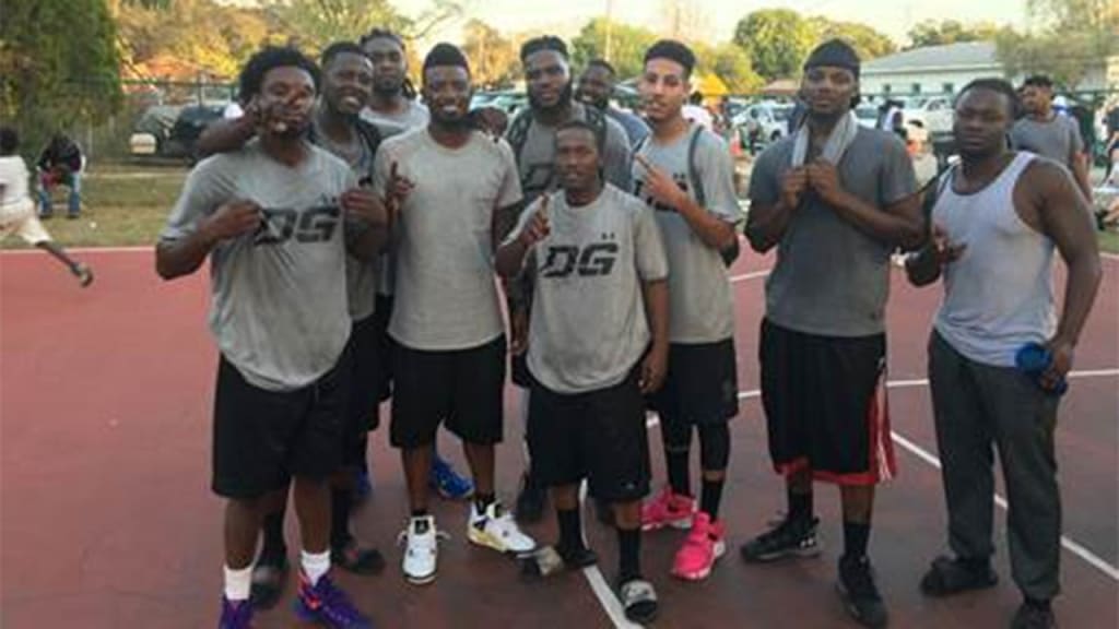 Dee Gordon celebrates with the first-place team at his hometown basketball tournament. (Toni Nocita)