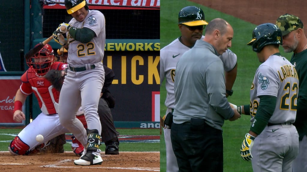 Oakland Athletics pitcher Frankie Montas, center, hands the ball