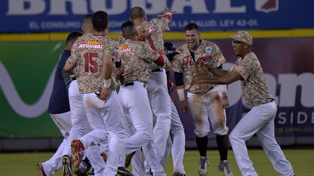 Junier Querequto (C) at Venezuelan celebrates a hit definitive against Dominican Republic during their 2016 Caribbean baseball series game, on February 2, In Santo Domingo city, Dominican Republic. / AFP / YAMIL LAGE (Photo credit should read YAMIL LAGE/AFP/Getty Images)