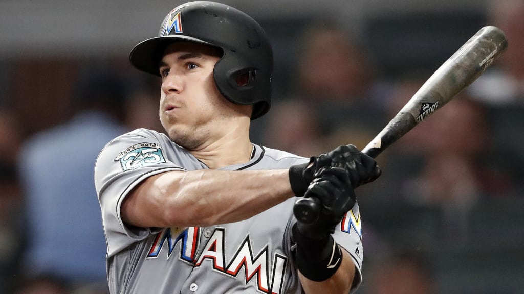 Miami Marlins' J.T. Realmuto follows through on two-run base hit in the fourth inning of a baseball game against the Atlanta Braves Tuesday, Aug. 14, 2018 in Atlanta. (AP Photo/John Bazemore)