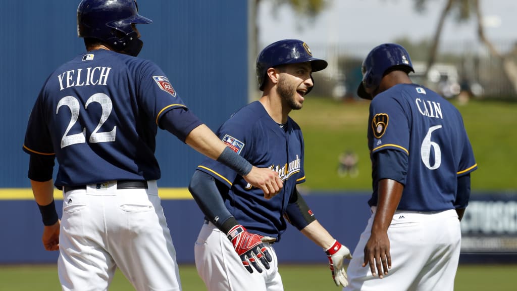 Milwaukee Brewers' Ryan Braun (8) high fives Christian Yelich (22) and Lorenzo Cain (6) after hitting a grand slam home run against the Chicago White Sox during the second inning of a spring training baseball game Wednesday, March 14, 2018, in Phoenix. (AP Photo/Matt York)
