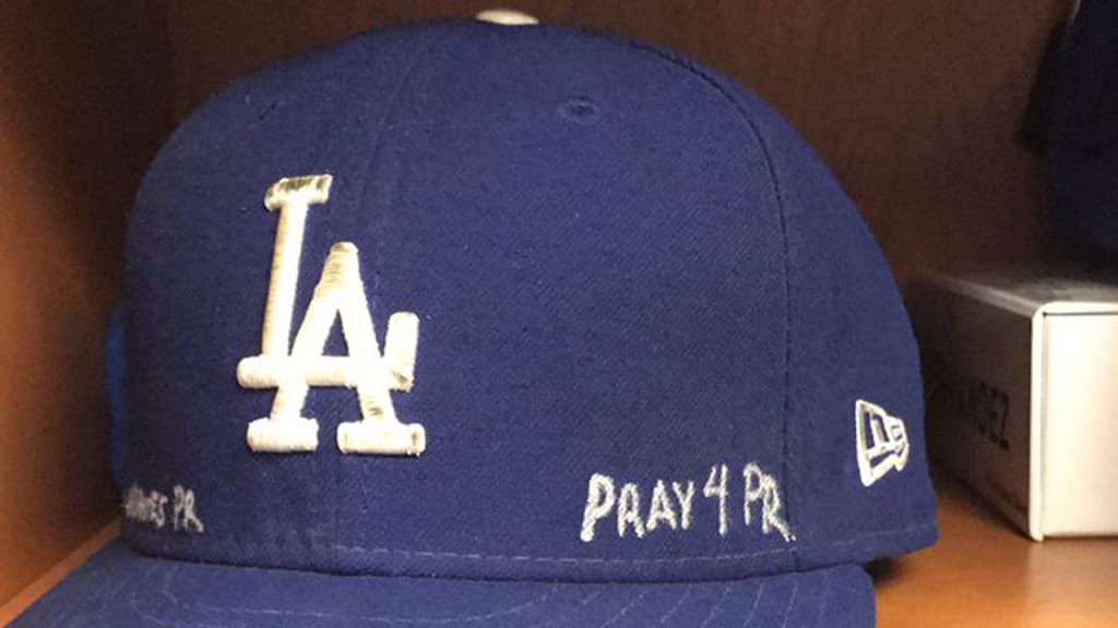 Enrique Hernandez's cap is inscribed with messages of support for Puerto Rico.