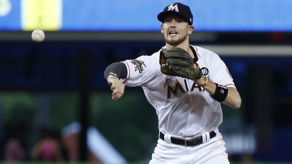 Miami Marlins shortstop JT Riddle throws to first base to attempt a double play after tagging the base to put out Philadelphia Phillies' Freddy Galvis (13) during the first inning of a baseball game, Tuesday, July 18, 2017, in Miami. Nick Williams was safe at first. (AP Photo/Wilfredo Lee)