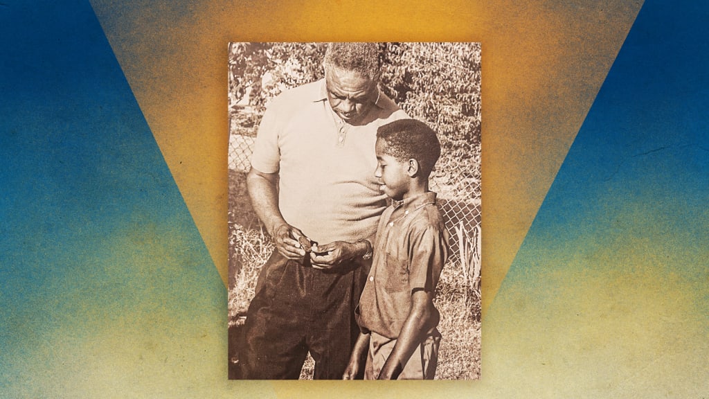 Mack Robinson sharing his 1936 Olympic 200 Meters Silver Medal, with his son Wayne in July 1968. (Photo by George F. Alexander for Newsweek)