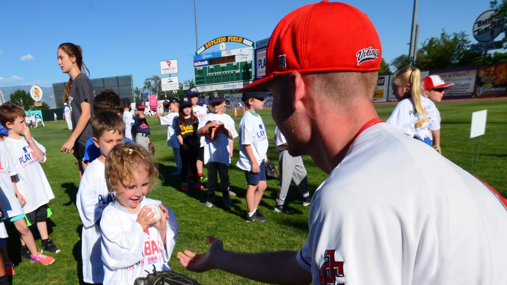 Jefferson College (Missouri) catcher Jacob Kalusniak throws a ball to 3-year-old Kenley Tice of Grand Junction during Major League Baseball's Play Ball Kids Camp on Thursday at Suplizio Field in Grand Junction, Colorado.