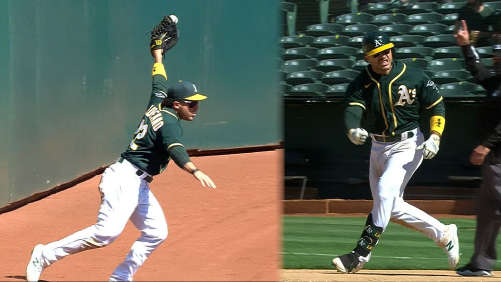 Oakland Athletics' Ramon Laureano, left, is tagged out by Houston