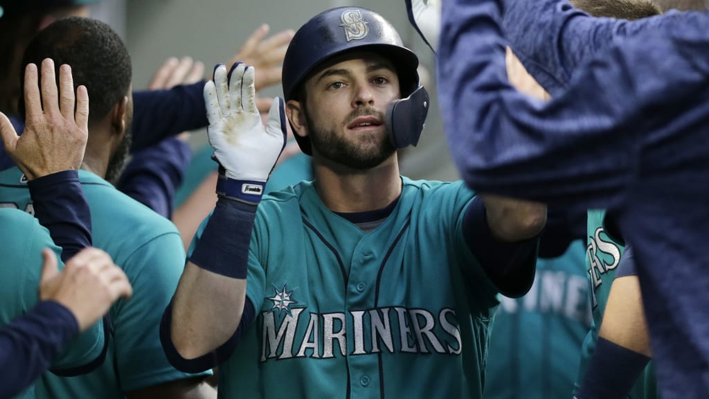 Seattle Mariners' Mitch Haniger is congratulated in the dugout after hitting a two-run home run against the Kansas City Royals during the fourth inning of a baseball game Friday, June 29, 2018, in Seattle. (AP Photo/John Froschauer)