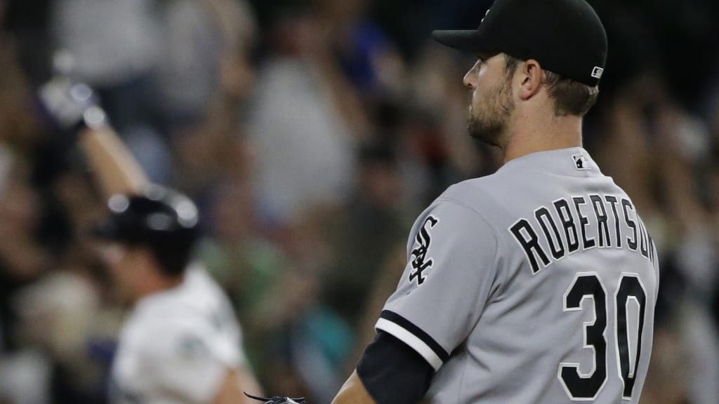 Seattle Mariners' Adam Lind rounds the bases as Chicago White Sox closer David Robertson looks on after Lind hit a three-run walk-off home run in the ninth inning Monday. (AP)