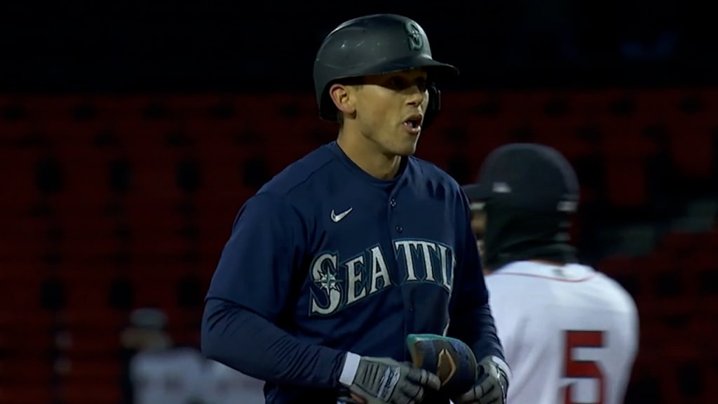 Seattle Mariners' Ty France holds his bat on his helmet after