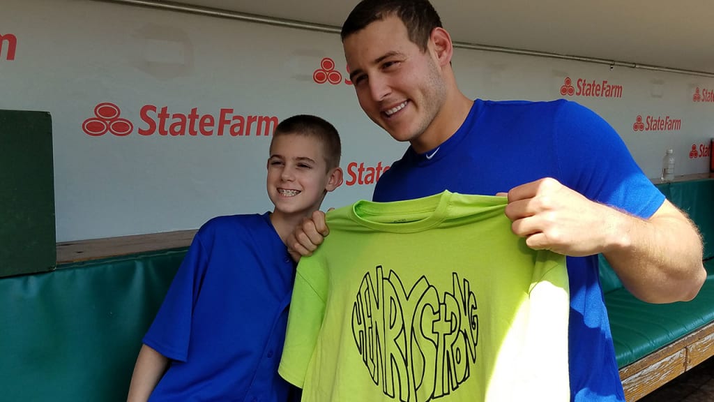 Anthony Rizzo poses in the Cubs' dugout with 13-year-old Henry Sembdner, toting a "Henry Strong" T-shirt. (Carrie Muskat)