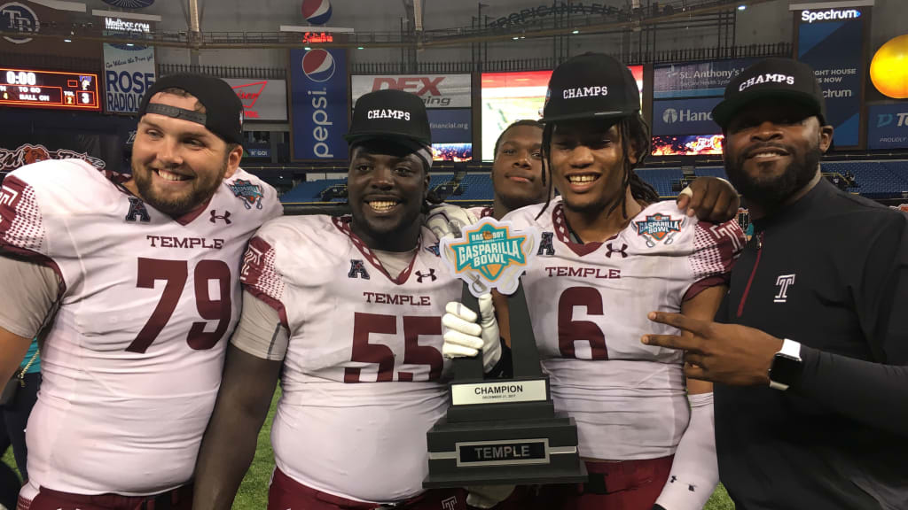 Temple players pose with the trophy after beating FIU at Tropicana Field on Thursday. (J. Scott Butherus)