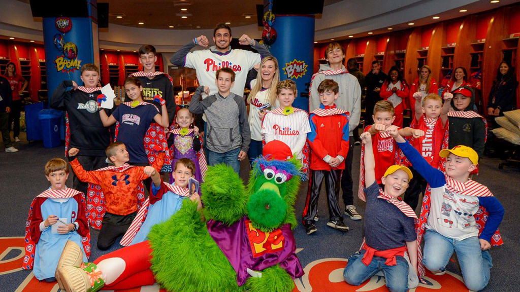 Zach Eflin poses with kids inside the home clubhouse at Citizens Bank Park. (Phillies)