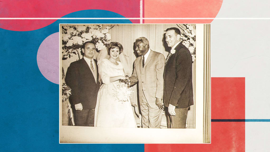 Jackie Robinson greeting Tom's wife Marilyn at their wedding.