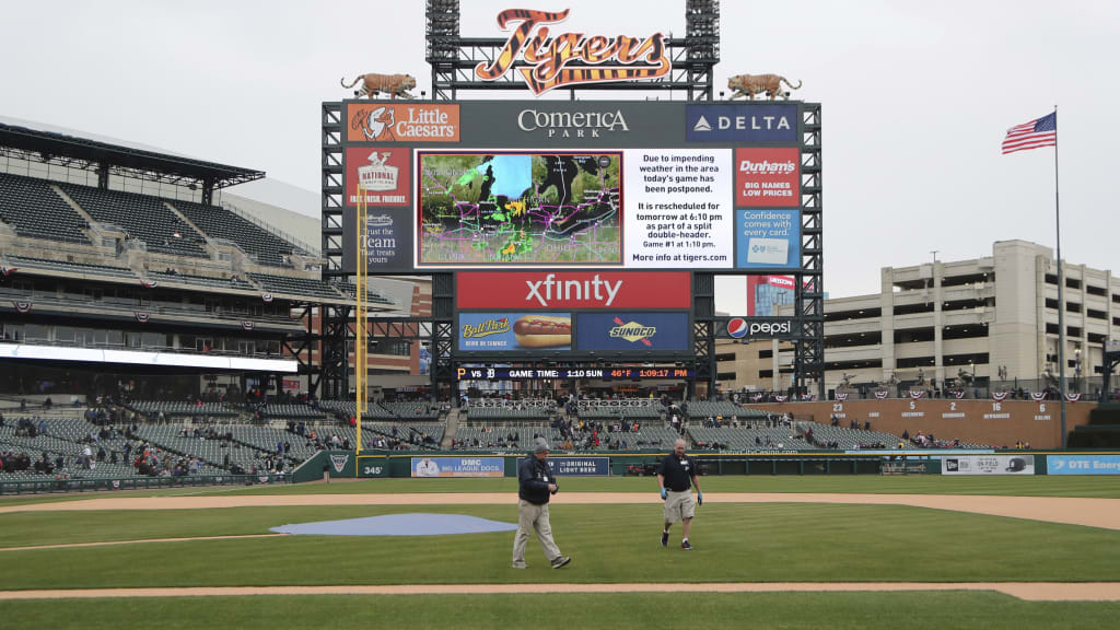 Comerica Park grounds crew prepare to roll out the tarp after the baseball game between the Detroit Tigers and the Pittsburgh Pirates was postponed, Saturday, March 31, 2018, in Detroit. The teams will play a doubleheader on Sunday. (AP Photo/Carlos Osorio)