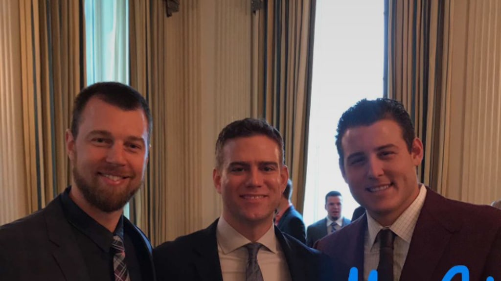 President Barack Obama smiles as Chicago Cubs first baseman Anthony Rizzo  and Chicago Cubs President of Baseball Operations Theo Epstein (R) present  him with a 'Chicago' Cubs away jersey during a ceremony