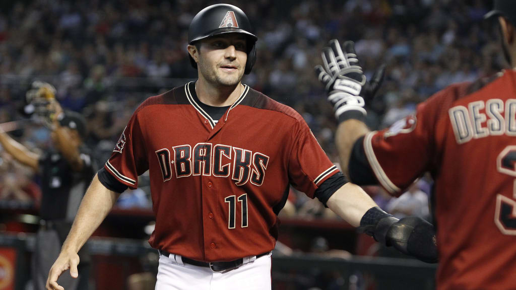 Arizona Diamondbacks' A.J. Pollock (11) is congratulated by teammate Daniel Descalso after scoring a run against the Colorado Rockies on a Steven Souza double during the first inning of a baseball game, Sunday, July 22, 2018, in Phoenix. (AP Photo/Ralph Freso)