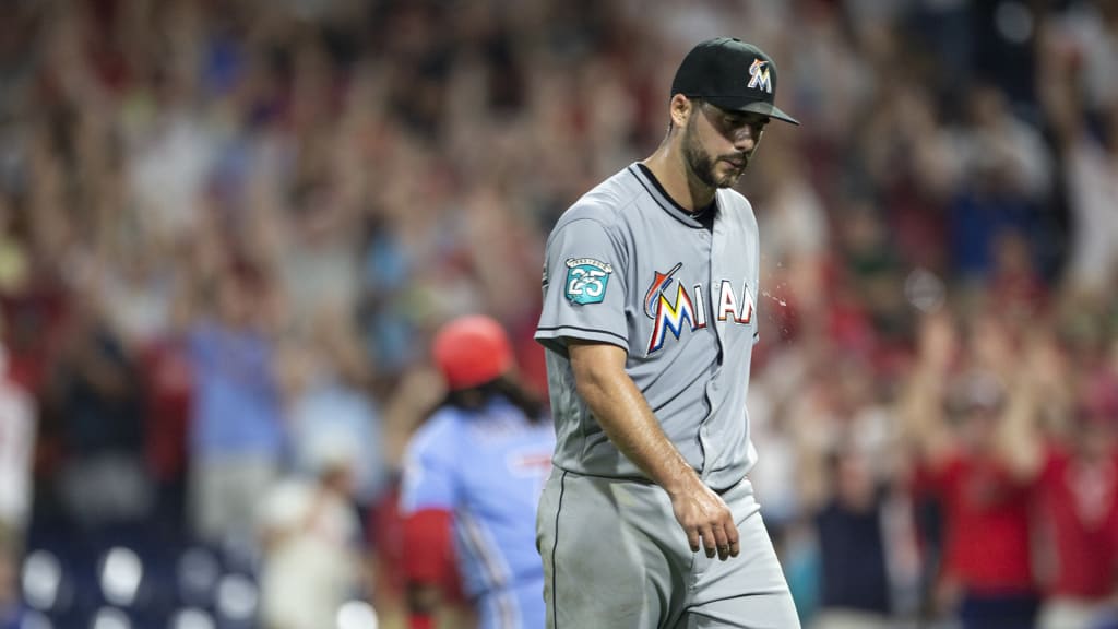 Miami Marlins relief pitcher Kyle Barraclough walks off the field after Philadelphia Phillies' Maikel Franco, rear, hit a walk-off three-run home run in a baseball game Thursday, Aug. 2, 2018, in Philadelphia. The Phillies won 5-2. (AP Photo/Laurence Kesterson)