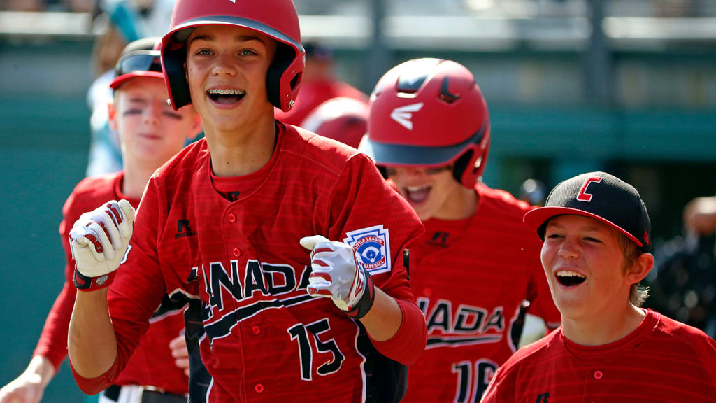 Canada's Reid Hefflick (15) celebrates with teammates as he returns to the dugout after hitting a three-run home run in the first inning. (AP)