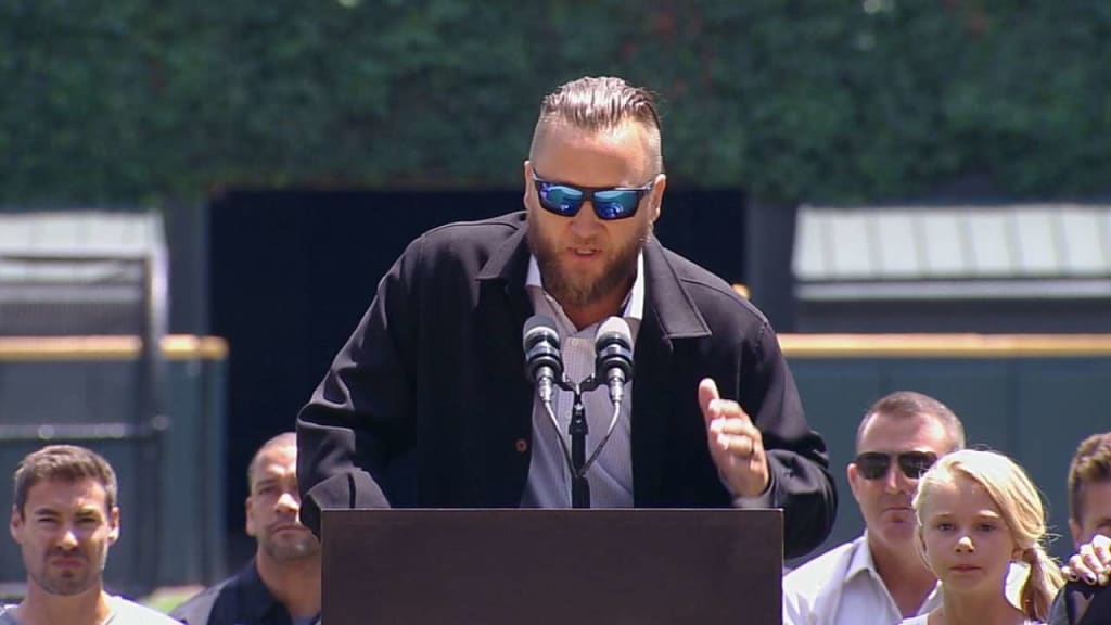 Former Chicago White Sox pitcher Mark Buehrle, left, watches with his wife  Jamie, right, daughter Brooklyn, and son Braden, as his No. 56, top right,  is retired during ceremonies before a baseball