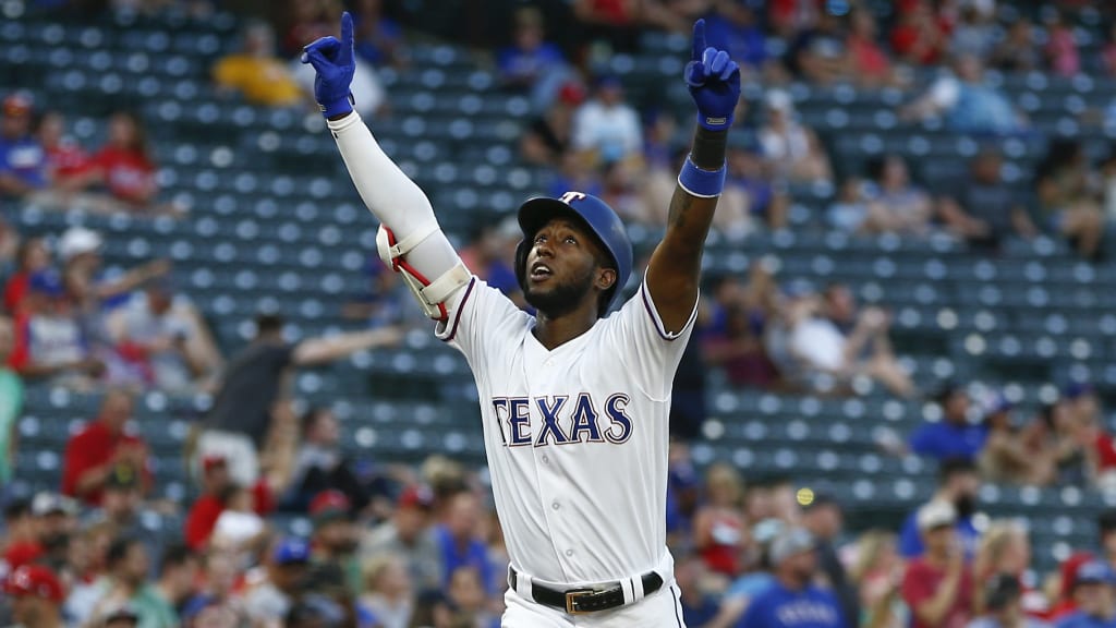Texas Rangers' Jurickson Profar points to the sky as he arrives home following his solo home run against the Oakland Athletics during the third inning of a baseball game, Wednesday, June 6, 2018, in Arlington, Texas. (AP Photo/Jim Cowsert)
