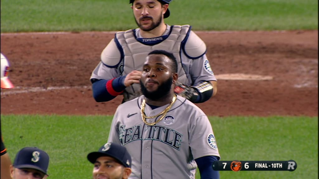 Seattle Mariners' Abraham Toro, left, scores past Los Angeles