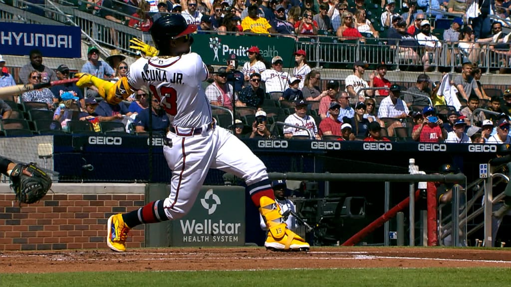 Atlanta Braves' Ronald Acuna Jr., right, high-five Freddie Freeman after  hitting a home run during the third inning of the team's baseball game  against the Miami Marlins on Wednesday, April 14, 2021