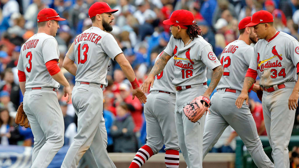 CHICAGO, IL - SEPTEMBER 29: Matt Carpenter #13 of the St. Louis Cardinals high fives Carlos Martinez #18 after their win oer the Chicago Cubs at Wrigley Field on September 29, 2018 in Chicago, Illinois. The St. Louis Cardinals won 2-1. (Photo by Jon Durr/Getty Images)