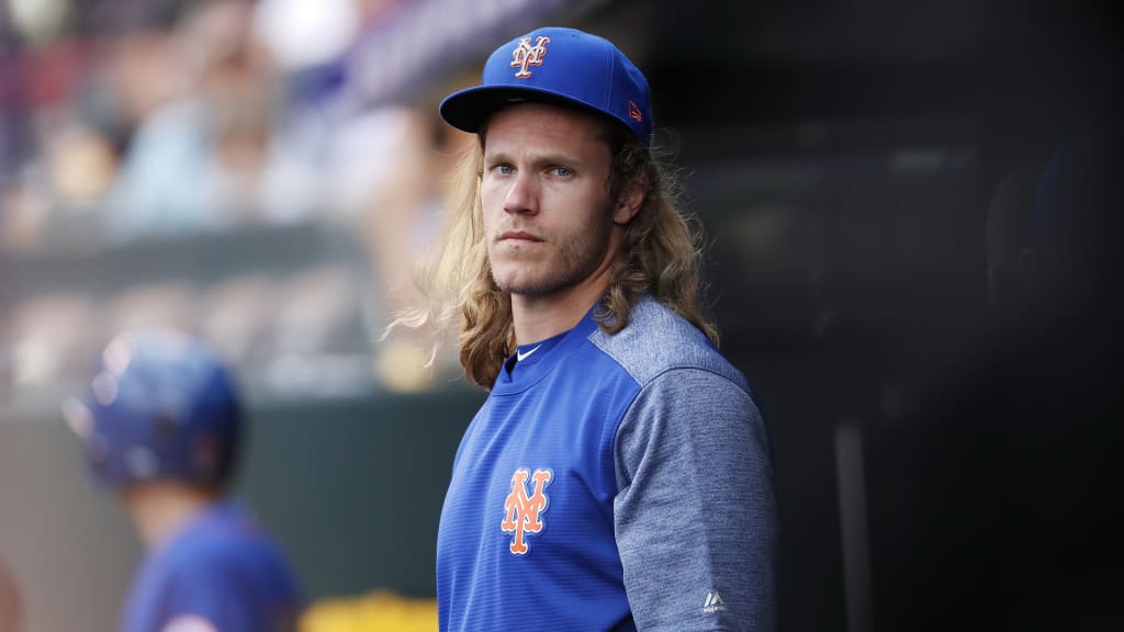 Injured New York Mets pitcher Noah Syndergaard watches from the dugout during the first inning of the team's baseball game against the Colorado Rockies on Wednesday, June 20, 2018, in Denver. (AP Photo/David Zalubowski)