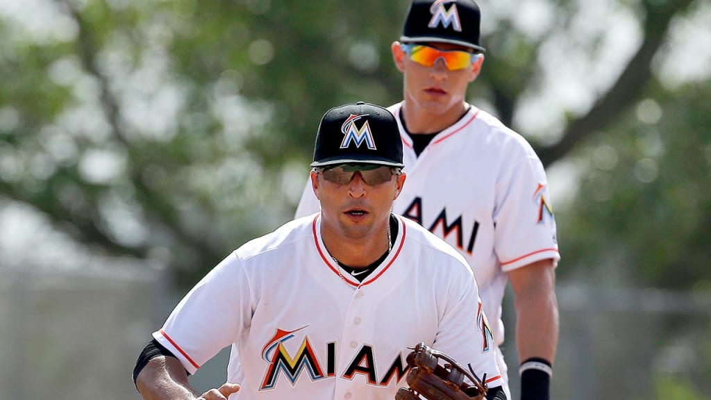 Young infielder/outfielder Derek Dietrich watches Martin Prado field a grounder on Wednesday. (AP)
