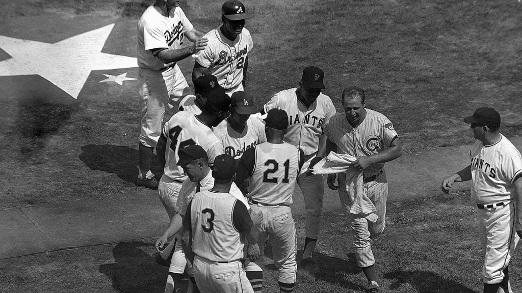 Members of the NL team congratulate Maury Wills after his game-winning hit. (AP)