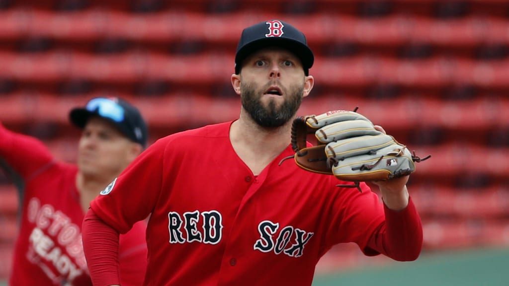 Boston Red Sox's Dustin Pedroia, right, and Brock Holt, left, catch and throw during a baseball workout at Fenway Park, Wednesday, Oct. 3, 2018, in Boston. The Red Sox face the winner of the Oakland Athletics-New York Yankees wild card game in the American League division series on Friday. (AP Photo/Elise Amendola)