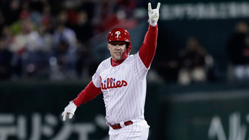 Rhys Hoskins of the Philadelphia Phillies celebrates by spiking