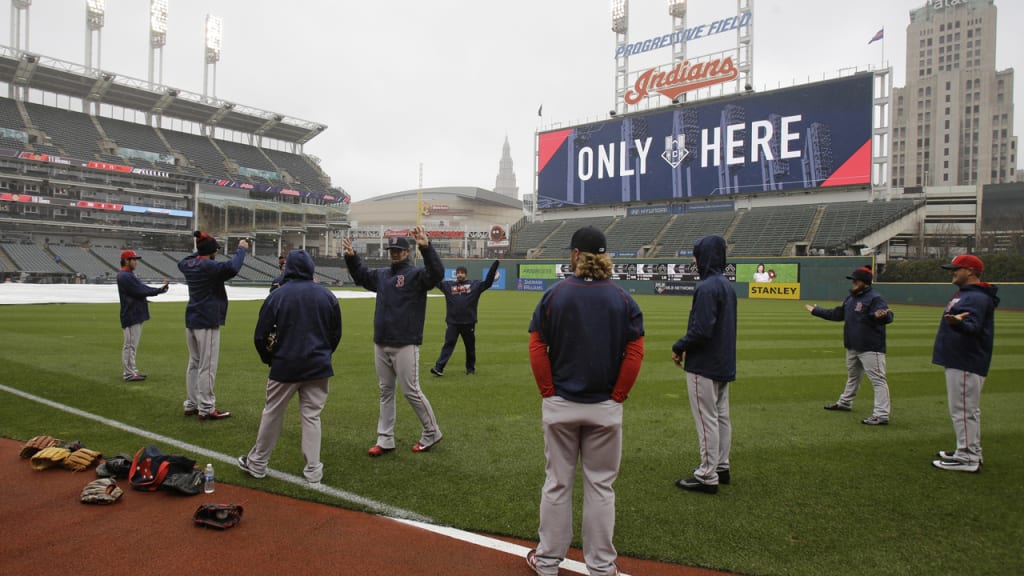 Members of the Red Sox stretch on the field prior to Monday's game being postpone. (AP)