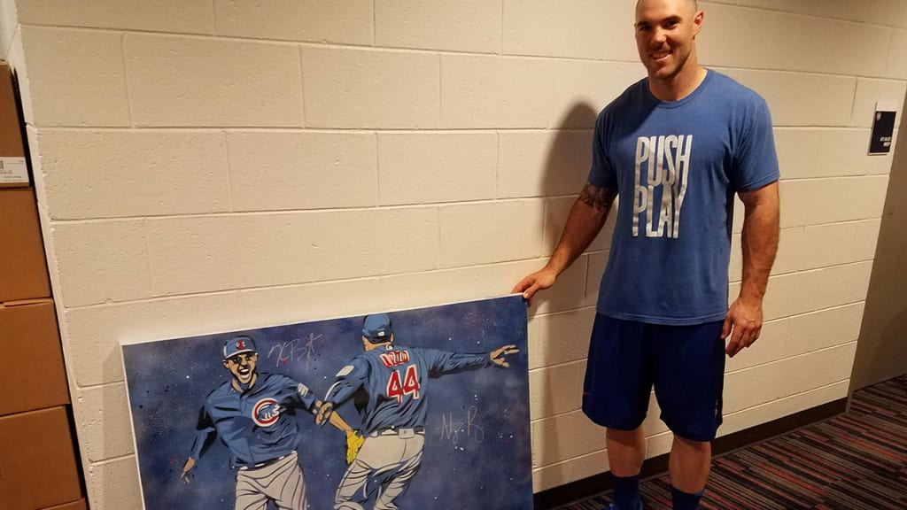 Matt Szczur poses next to his Game 7 painting during Spring Training. (MLB.com)