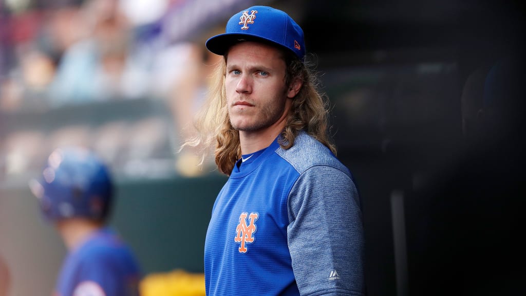 Mets pitcher Noah Syndergaard watches from the dugout during the first inning of a game against the Rockies on June 20, 2018, in Denver.