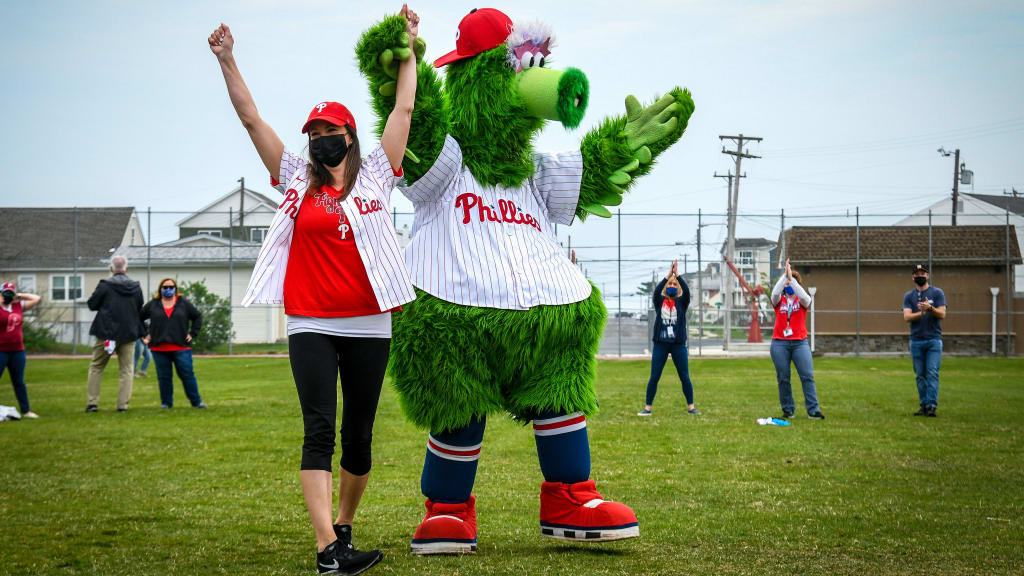 Mindy Pomatto and the Phillie Phanatic raise their arms in victory.