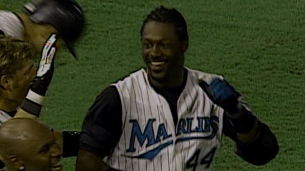 Former Miami Marlins player Jeff Conine, center, holds a jersey