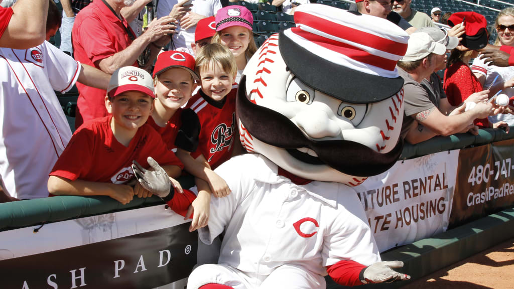 The Cincinnati Reds mascot Mr. Redlegs sits in the dugout during