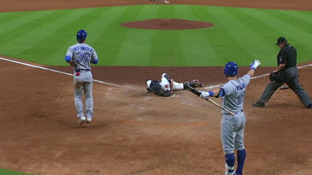 The ball, a double hit to right field by Toronto Blue Jays' Ryan Goins pops  out of New York Yankees catcher Brian McCann's glove as he attempts to put  the tag on