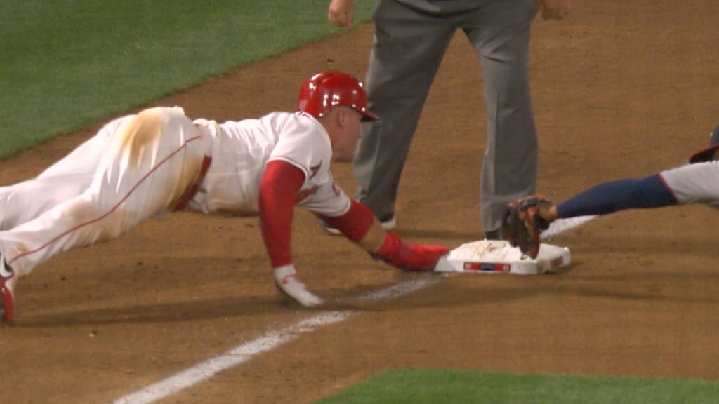 American League's Mike Trout (27) slides in safe ahead of the tag