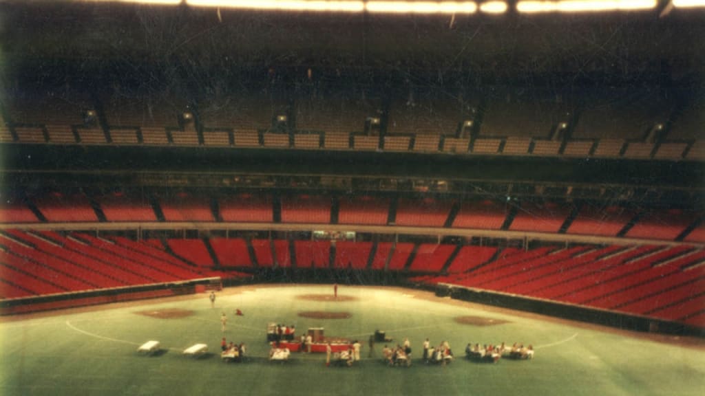 The Astros served food on the field for those who were trapped at the Astrosdome during flooding. (Astros)